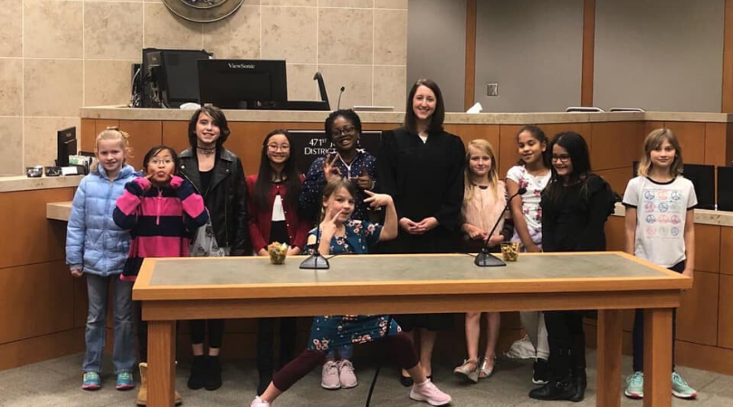 Andrea Bouressa with children in the court