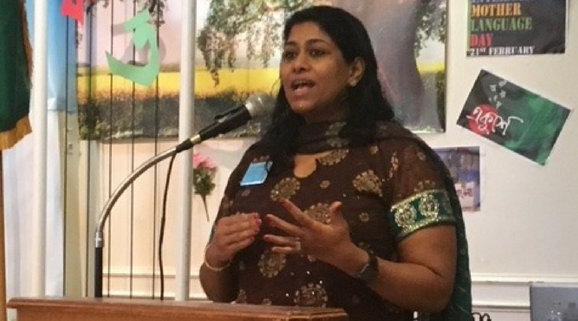 Juli Mathew speaking in front of people