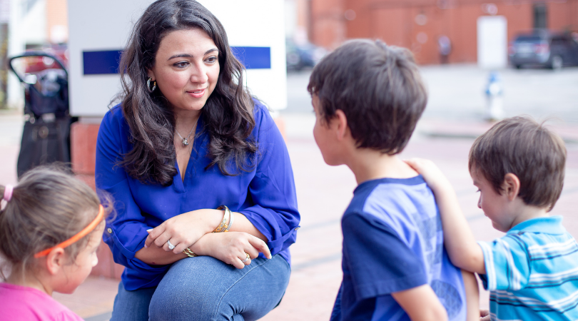 Lulu Seikaly talking with children